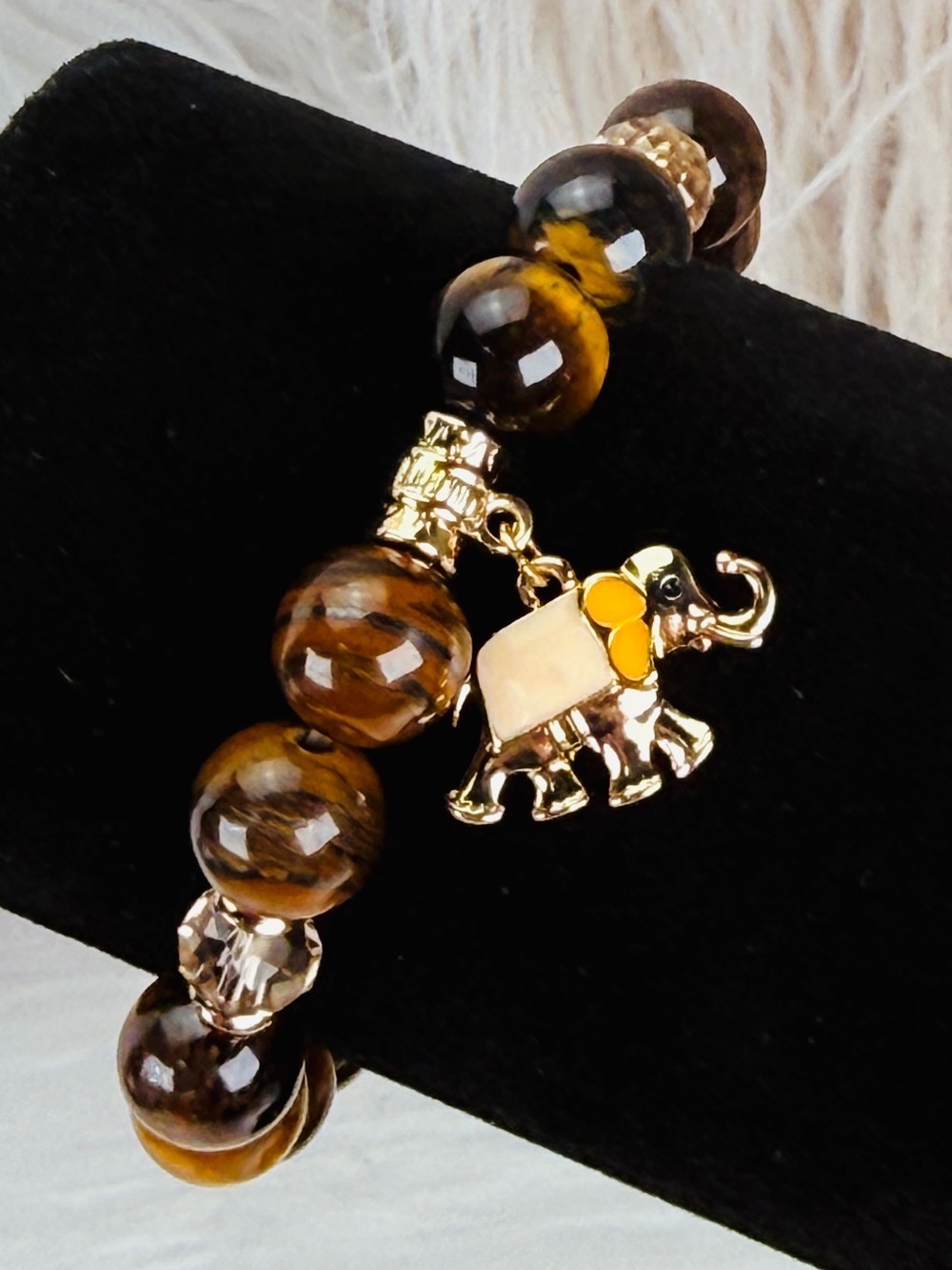 Beautiful goldtone and enamel elephant charm tigers eye stretch bracelet